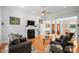 Open-concept living room boasts hardwood floors, a fireplace and a view of the entryway at 172 Hunters Hill Dr, Statesville, NC 28677