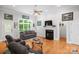 Bright living room featuring a fireplace with black marble surround and hardwood floors at 172 Hunters Hill Dr, Statesville, NC 28677