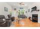 Bright living room featuring hardwood floors, a fireplace, and large windows for natural light at 172 Hunters Hill Dr, Statesville, NC 28677
