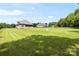 Sprawling backyard showcasing ample green space and two beautiful homes amid a serene, sunny landscape at 174 Bellingshire Dr, Mt Ulla, NC 28125