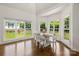 Bright dining room with many windows allowing for lots of natural light and hardwood floors at 174 Bellingshire Dr, Mt Ulla, NC 28125