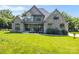 Charming stone-front house with a well-manicured lawn and covered front porch at 174 Bellingshire Dr, Mt Ulla, NC 28125