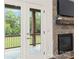 French doors leading to the outside, fireplace with a stone facade, a mantel, and a TV at 174 Bellingshire Dr, Mt Ulla, NC 28125