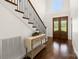 Elegant foyer with hardwood floors, staircase with iron railing, and decorative console table at 174 Bellingshire Dr, Mt Ulla, NC 28125