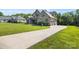 Gorgeous two-story home with stone accents, a long driveway, and lush landscaping, set on a sunny lot at 174 Bellingshire Dr, Mt Ulla, NC 28125
