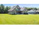 Beautiful home with a well-manicured lawn and stone exterior accents at 174 Bellingshire Dr, Mt Ulla, NC 28125