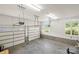Bright garage interior featuring windows, painted walls and ceiling, and two garage doors at 174 Bellingshire Dr, Mt Ulla, NC 28125