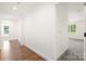 Hallway showcases wood flooring and bright white walls, offering a seamless transition to rooms at 174 Bellingshire Dr, Mt Ulla, NC 28125