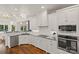 Bright kitchen features white cabinets, stainless steel appliances, granite countertops, and hardwood floors at 174 Bellingshire Dr, Mt Ulla, NC 28125