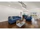 Open-concept living area with blue furniture, hardwood floors and a view of the kitchen and dining area at 174 Bellingshire Dr, Mt Ulla, NC 28125