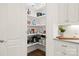 Well-organized pantry with white shelving and storage near granite countertops at 174 Bellingshire Dr, Mt Ulla, NC 28125