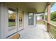 Covered patio with wood columns and ornate railing, providing a relaxing outdoor space overlooking lush greenery at 174 Bellingshire Dr, Mt Ulla, NC 28125