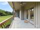 Covered patio with wood railing offers an excellent view of the expansive backyard, perfect for relaxation and entertainment at 174 Bellingshire Dr, Mt Ulla, NC 28125
