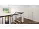 Elegant staircase features a wrought iron railing and view of the foyer chandelier at 174 Bellingshire Dr, Mt Ulla, NC 28125
