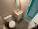 Features a toilet, small vanity with sink, and neutral wall color at 1824 Maribel Ave, Charlotte, NC 28216
