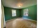 Cozy bedroom offering natural light and new floors, creating a comfortable retreat at 1824 Maribel Ave, Charlotte, NC 28216