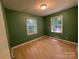 Comfortable bedroom with windows and wood-look flooring at 1824 Maribel Ave, Charlotte, NC 28216