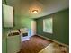 Traditional kitchen featuring an oven, sink, window and wood-look flooring at 1824 Maribel Ave, Charlotte, NC 28216