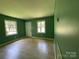 Inviting living room with natural light, featuring new flooring and fresh green paint at 1824 Maribel Ave, Charlotte, NC 28216