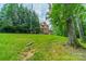 Spacious backyard featuring mature trees and a swing at 2004 Viscount Dr, Matthews, NC 28104