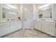 Well-lit bathroom featuring double sinks with white cabinets and tiled flooring at 2004 Viscount Dr, Matthews, NC 28104