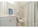 Bright bathroom featuring a tub with shower, white vanity, and neutral walls at 2004 Viscount Dr, Matthews, NC 28104