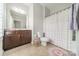 Cozy bathroom showcasing a wooden vanity, toilet, and colorful shower curtain at 2004 Viscount Dr, Matthews, NC 28104