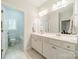 Bathroom featuring double sinks, white cabinets, and tile flooring with views into other rooms for convenience at 2004 Viscount Dr, Matthews, NC 28104