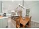 An open-concept dining area adjacent to the modern kitchen is well-lit with hardwood floors at 2004 Viscount Dr, Matthews, NC 28104