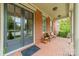 Charming front porch features brick flooring, double doors, and a cozy bench with pillows at 2004 Viscount Dr, Matthews, NC 28104