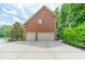 Spacious two-car garage with a brick exterior and ample driveway space at 2004 Viscount Dr, Matthews, NC 28104