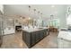 Open kitchen and living room space boasts hardwood flooring, modern lighting and white marble counters at 2004 Viscount Dr, Matthews, NC 28104