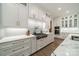 A stylish kitchen featuring white cabinetry, quartz countertops, and stainless steel appliances offers modern elegance at 2004 Viscount Dr, Matthews, NC 28104