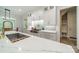 Well lit kitchen featuring white cabinets, a tile backsplash, hardwood floors, and stainless steel appliances at 2004 Viscount Dr, Matthews, NC 28104