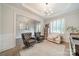 Inviting living room boasts hardwood floors, modern lighting, and comfortable seating and shelving at 2004 Viscount Dr, Matthews, NC 28104