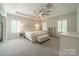 Spacious main bedroom with a tray ceiling, neutral decor, a ceiling fan and plush carpeting at 2004 Viscount Dr, Matthews, NC 28104