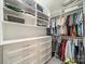 Organized walk-in closet with shelving, drawers, and hanging rods for ample storage at 2004 Viscount Dr, Matthews, NC 28104