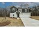 Charming two-story home with a gray and white facade, a two-car garage, and a well-manicured front yard at 2142 Sunflower Cir, Newton, NC 28658