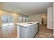 A kitchen island offers a sink, cabinet storage and dining space, with an open view of the living room at 2142 Sunflower Cir, Newton, NC 28658