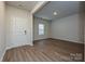 Bright living room featuring wood-look flooring and a front door at 2142 Sunflower Cir, Newton, NC 28658