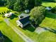 Aerial view of property showcasing the home, ample yard space, mature trees, and outbuildings at 24007 Old Aquadale Rd, Albemarle, NC 28001