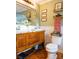 Charming bathroom featuring a vanity with drawers, a mirror, decor and a toilet at 24007 Old Aquadale Rd, Albemarle, NC 28001