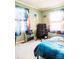 Well-lit bedroom with colorful curtains, cozy carpet, and a corner for computer use at 24007 Old Aquadale Rd, Albemarle, NC 28001