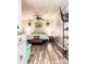 This bedroom features wood floors, a ceiling fan, and a closet rack for shoe storage at 24007 Old Aquadale Rd, Albemarle, NC 28001