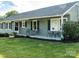 Inviting front porch with table and chairs provides an outdoor seating area at 24007 Old Aquadale Rd, Albemarle, NC 28001