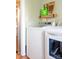 Efficient laundry area with modern washer and dryer, complemented by rustic decor accents at 24007 Old Aquadale Rd, Albemarle, NC 28001