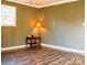 Inviting living room featuring laminate flooring and a vintage floor lamp providing warm, ambient lighting at 24007 Old Aquadale Rd, Albemarle, NC 28001