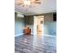 Spacious living room with sleek flooring, mini-split system, and convenient access to other areas of the home at 24007 Old Aquadale Rd, Albemarle, NC 28001