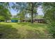 Expansive backyard with lush green grass and mature trees, providing a private and peaceful outdoor space at 2500 Kendrick Dr, Charlotte, NC 28214