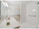 All-white bathroom with a walk-in shower and accessibility features at 2500 Kendrick Dr, Charlotte, NC 28214
